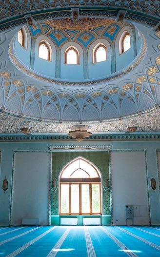 Mosque architecture framed by a traditional Islamic arch